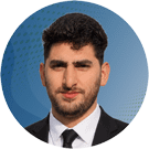 Abdul Professional headshot of a man in a dark suit and tie, posed against a blue circular gradient background.
